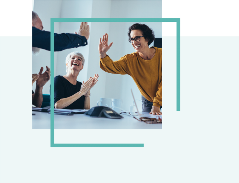 Employees high fiving at work - The Employee Experience behind Business Transformation